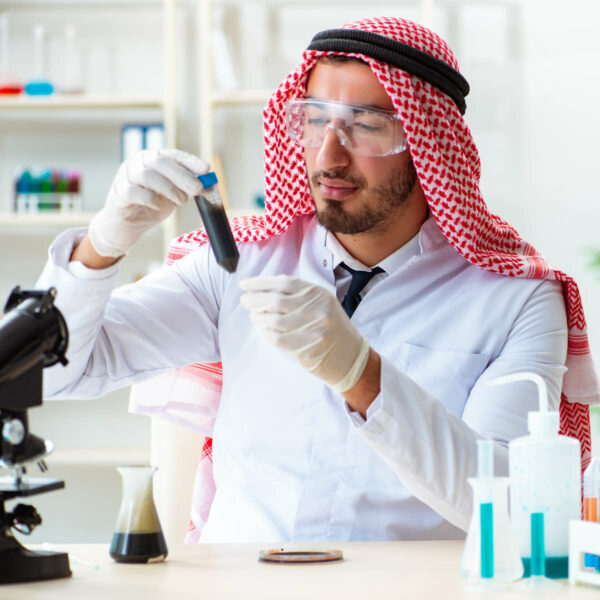 Arab chemist scientist testing quality of oil petrol